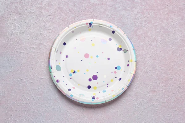 Paper disposable plate on grunge background