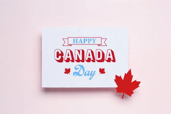 Card with text HAPPY CANADA DAY on beige background