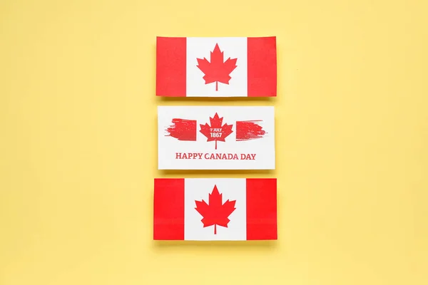 Card with text HAPPY CANADA DAY, date 1 JULY 1867 and flags on yellow background