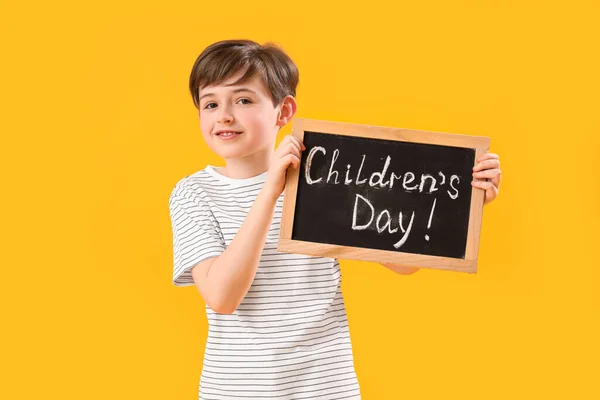 Little Boy Holding Chalkboard Text Children Day Yellow Background — Stock Photo, Image