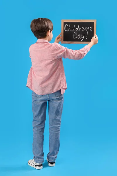 Little Boy Holding Chalkboard Text Children Day Blue Background Back — Stock Photo, Image
