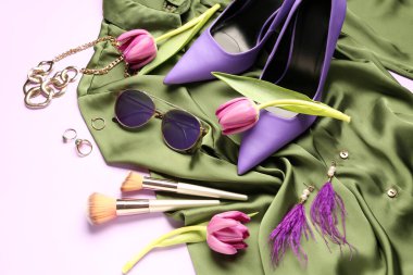 Renkli kadın aksesuarları, makyaj fırçaları, topuklu ayakkabılar ve lale çiçekleriyle beste