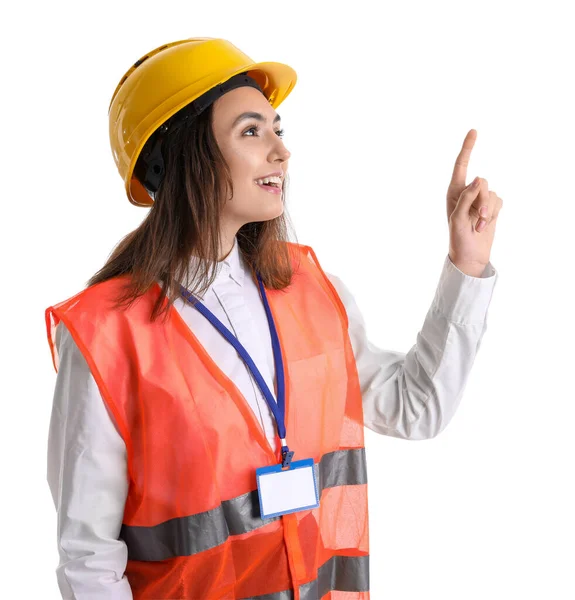 Vrouwelijke Werkneemster Vest Helm Wijzend Iets Witte Achtergrond — Stockfoto