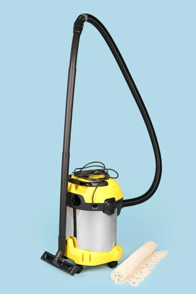 Vacuum Cleaner Rolled Carpet Blue Background — Stock Photo, Image