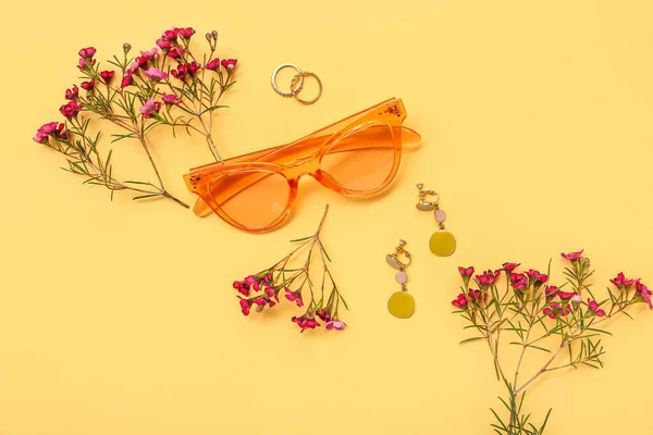 stock image Composition with stylish female accessories and wild flowers on color background