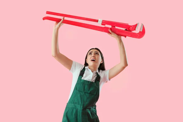 Worried Female Plumber Big Pipe Wrench Pink Background — Stock Photo, Image
