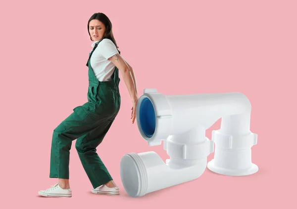 Worried Female Plumber Big Pipe Pink Background — Stock Photo, Image