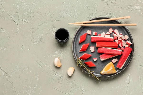 stock image Plate with tasty crab sticks and sauce on light background