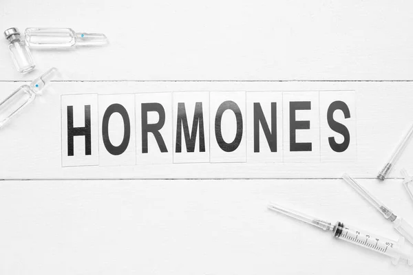 Word Hormones Syringes Ampules White Wooden Background — Stock Photo, Image