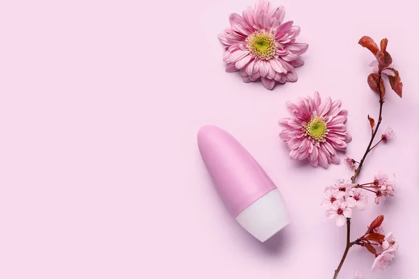 stock image Deodorant with flowers and blooming branch on pink background