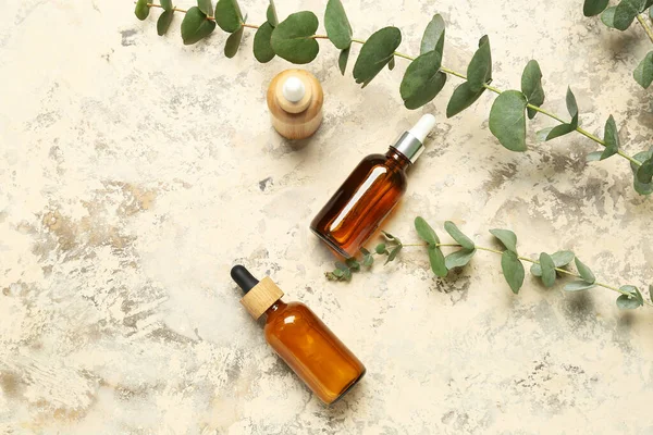 Bottles Cosmetic Oil Eucalyptus Branches Textured Background — Stock Photo, Image