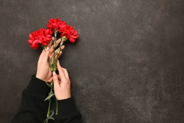 Female Hands Holding Red Carnations Dark Grunge Background — Stock Photo, Image