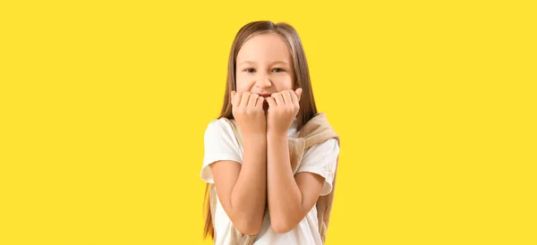 Little Girl Biting Nails Yellow Background — Stockfoto