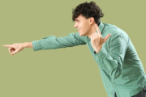 Young Man Showing Loser Gesture Pointing Something Green Background — Stock Photo, Image