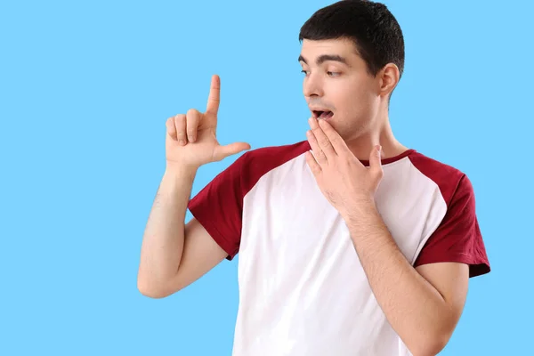 Shocked Young Man Showing Loser Gesture Blue Background — Stock Photo, Image