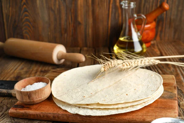 stock image Board with fresh lavash on wooden background