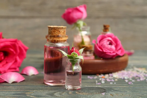 Bottles Cosmetic Oil Rose Extract Flowers Wooden Table — Stock Photo, Image