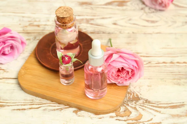 Bottles Cosmetic Oil Rose Extract Flowers Light Wooden Table — Stock Photo, Image