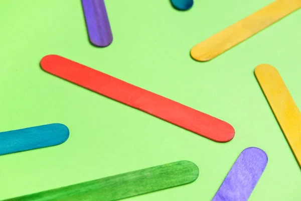 stock image Colorful ice cream sticks on green background, closeup