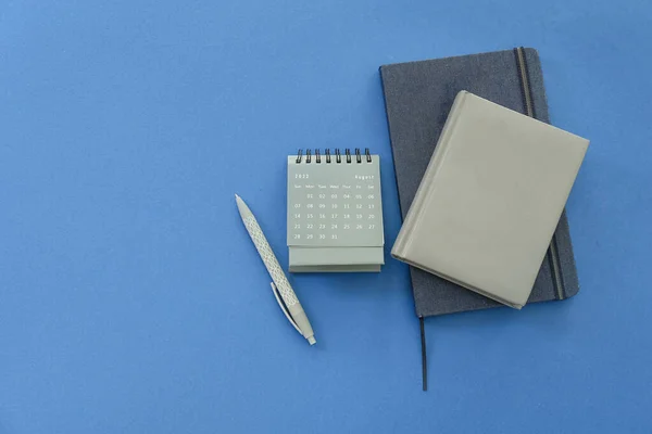 Flip Paper Calendar August Notebooks Pen Blue Background — Stock Photo, Image
