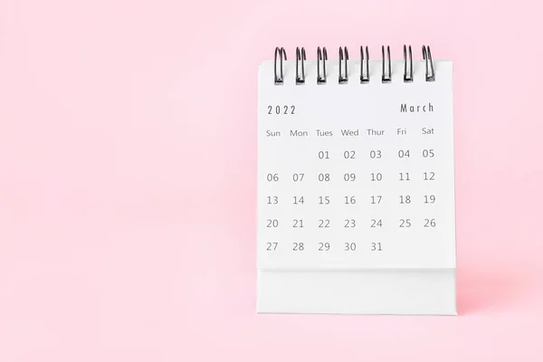 Flip paper calendar for March on pink background