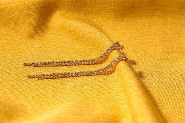 Beautiful Earrings Yellow Fabric Background — Stock Photo, Image