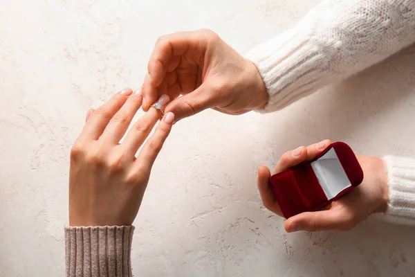 Man Sätta Förlovningsring Kvinnans Finger Mot Vit Bakgrund — Stockfoto