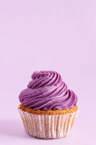 stock image Tasty cupcake on purple background