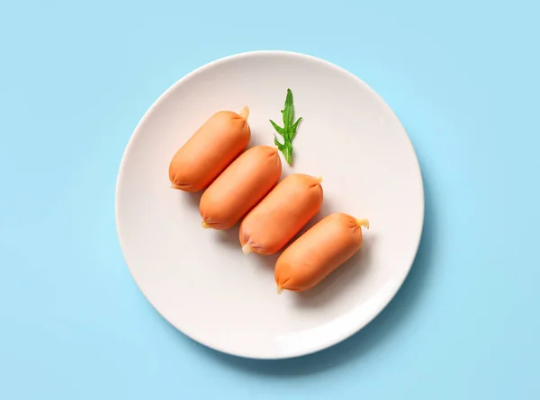 Plate Tasty Boiled Sausages Arugula Blue Background — Stock Photo, Image