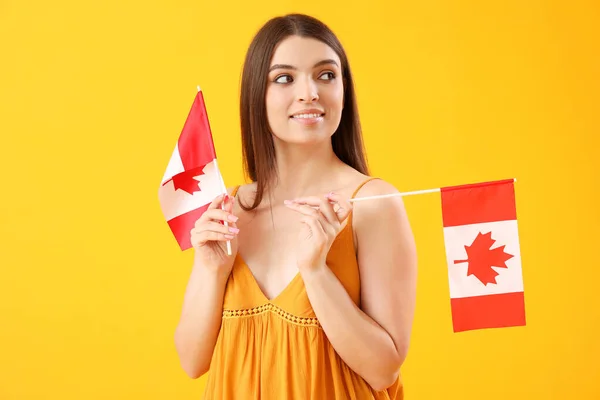 Młoda Kobieta Flagami Kanady Żółtym Tle — Zdjęcie stockowe