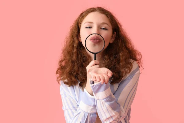 Молода Жінка Збільшувачем Дме Поцілунок Рожевому Фоні Крупним Планом — стокове фото