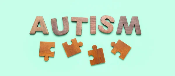 Word Autism Jigsaw Puzzle Pieces Turquoise Background — Stock Photo, Image