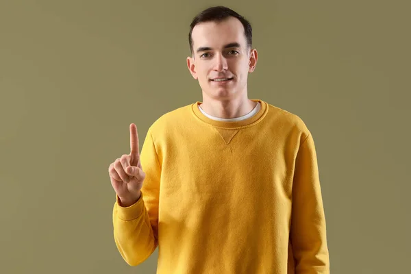 Young Man Showing One Finger Green Background — Stock Photo, Image