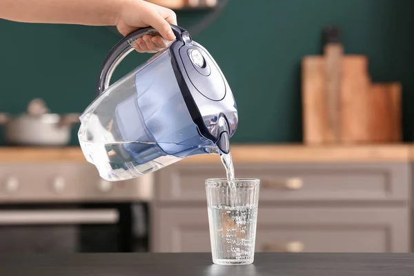 Woman Pouring Water Filter Jug Glass Black Table — Stock Photo, Image