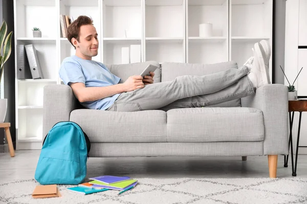 Male Student Tablet Computer Lying Sofa Home — Stock Photo, Image