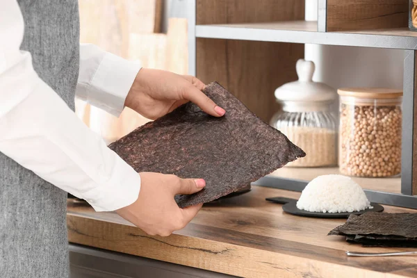 stock image Woman holding nori sheet for delicious sushi rolls