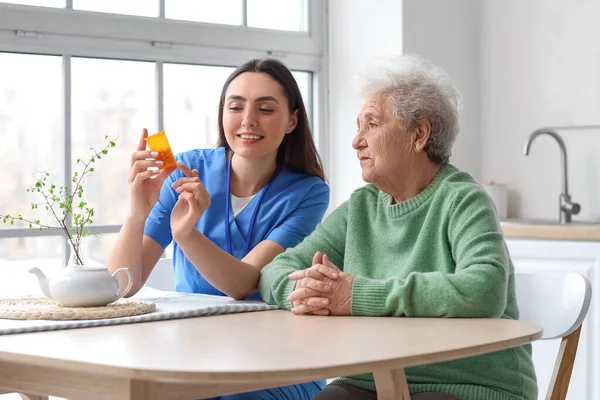 Young Caregiver Senior Woman Taking Pills Kitchen — Stock Photo, Image