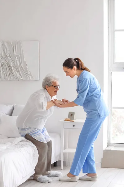 Young Caregiver Helping Senior Woman Stick Stand Bedroom — Stock Photo, Image
