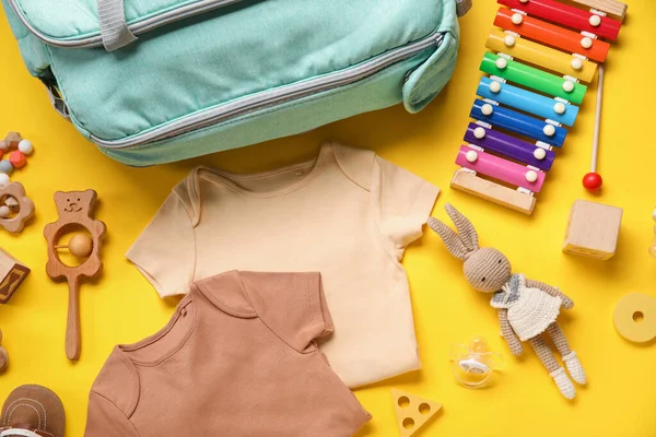 stock image Composition with baby clothes and toys on yellow background