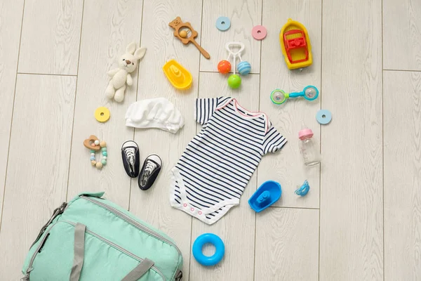 Stylish Bag Clothes Toys Baby Light Wooden Background — Stock Photo, Image