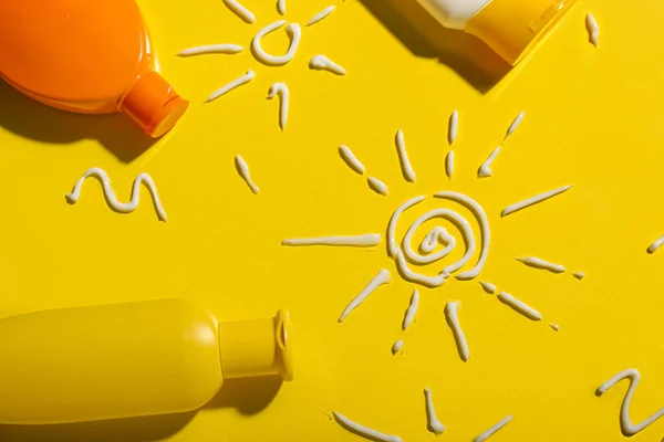stock image Drawings of suns made with sunscreen cream on yellow background