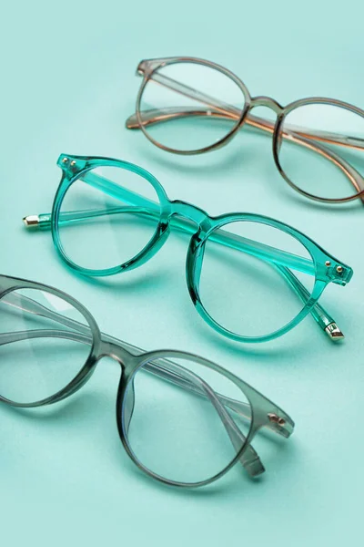Different New Eyeglasses Pale Turquoise Background — Stock Photo, Image