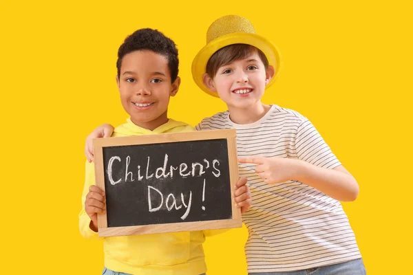 Little Boys Holding Chalkboard Text Children Day Yellow Background — Stock Photo, Image