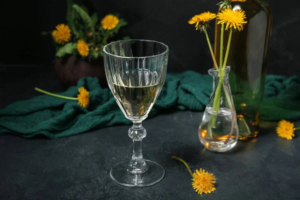 stock image Glass of dandelion wine on dark table