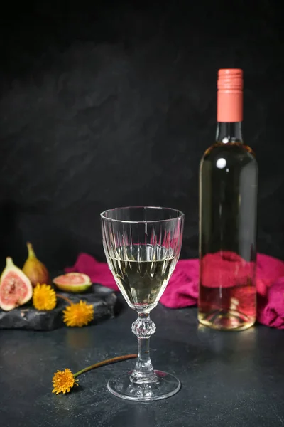 stock image Bottle and glass of dandelion wine on dark table