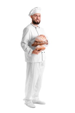 Male baker with loaves of fresh bread on white background