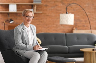 Ofiste oturan yetişkin psikolog.