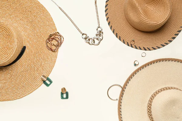 stock image Frame made of summer hats with jewelry on light background