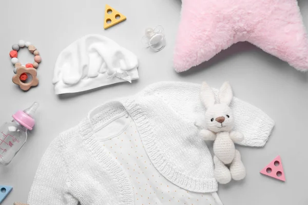 灰色背景的婴儿服装 玩具和配件的组合 — 图库照片