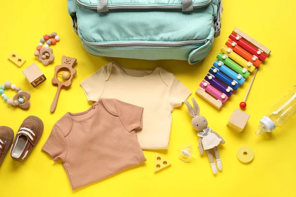 stock image Composition with baby clothes and toys on yellow background